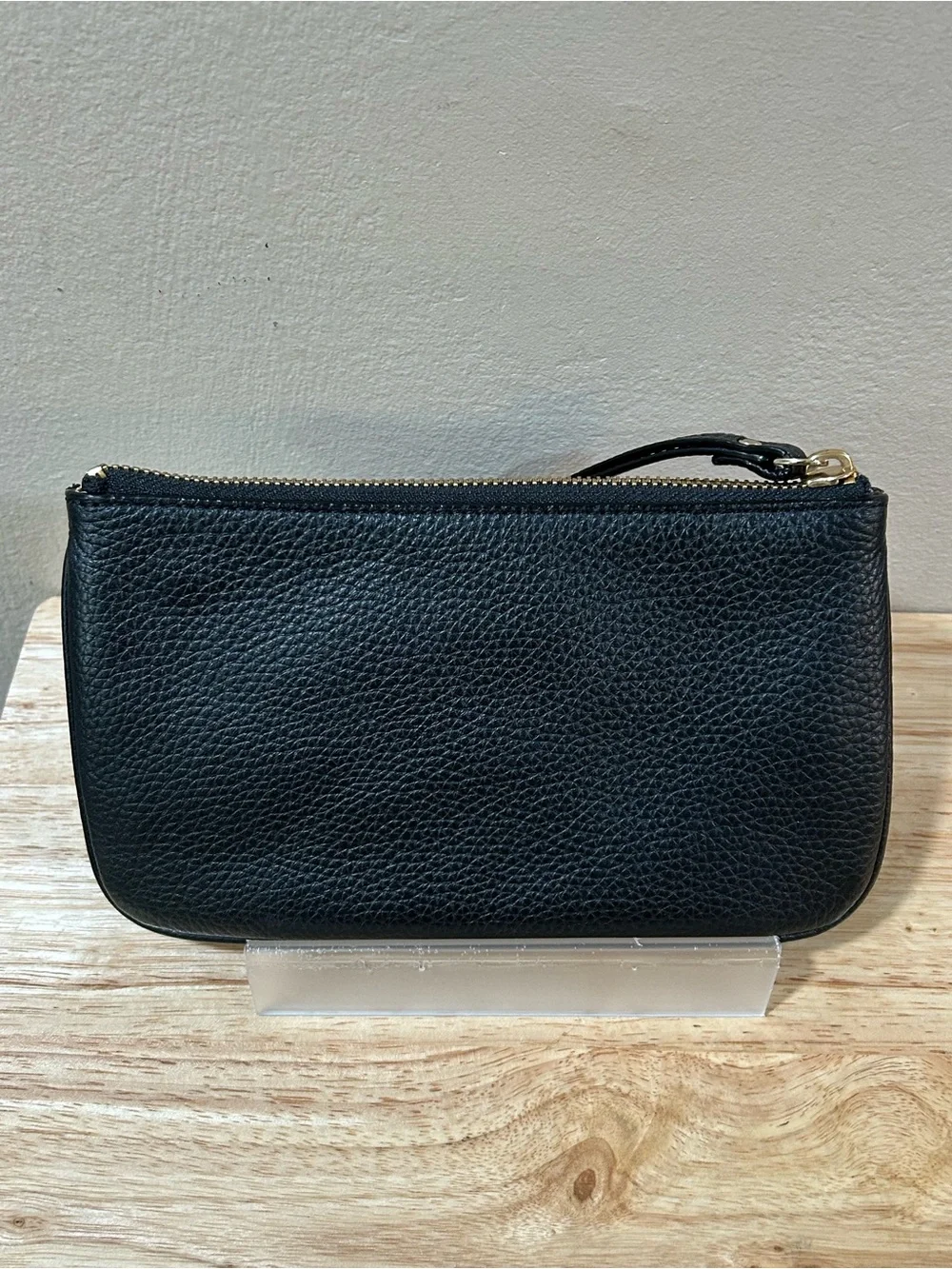kate spade black pebbled leather wristlet with gold-tone logo